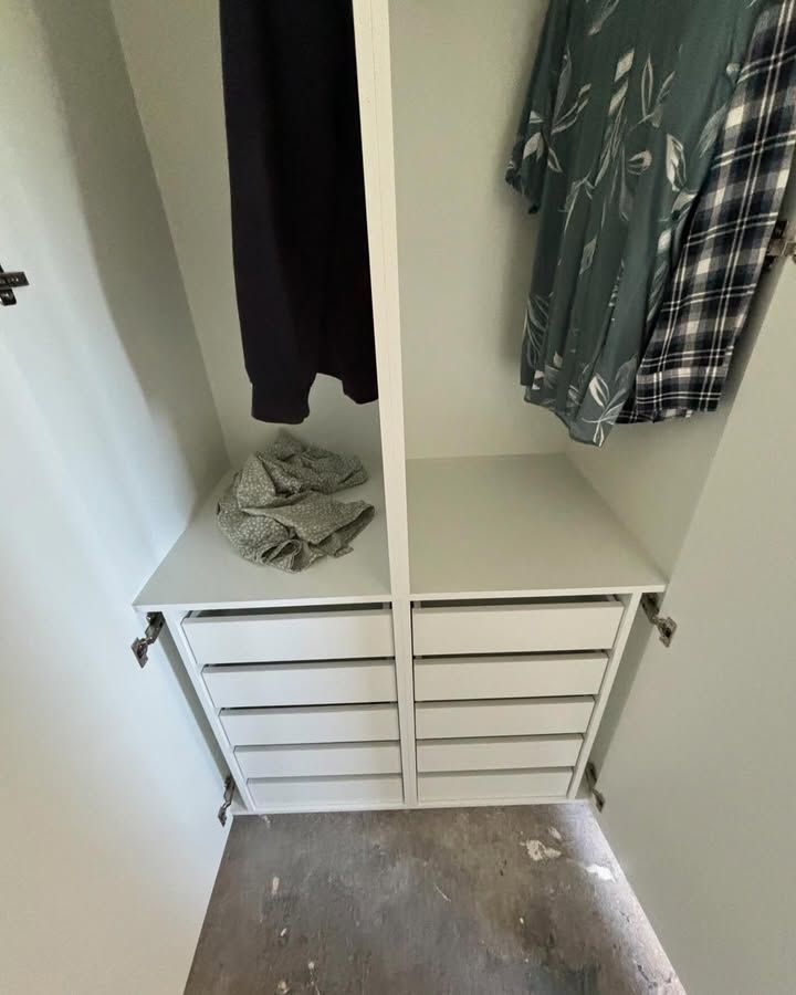 Open Closet With Hanging Clothes, Folded Items, and White Drawer Organizers— Piscopo Kitchens Plus In Forster, NSW