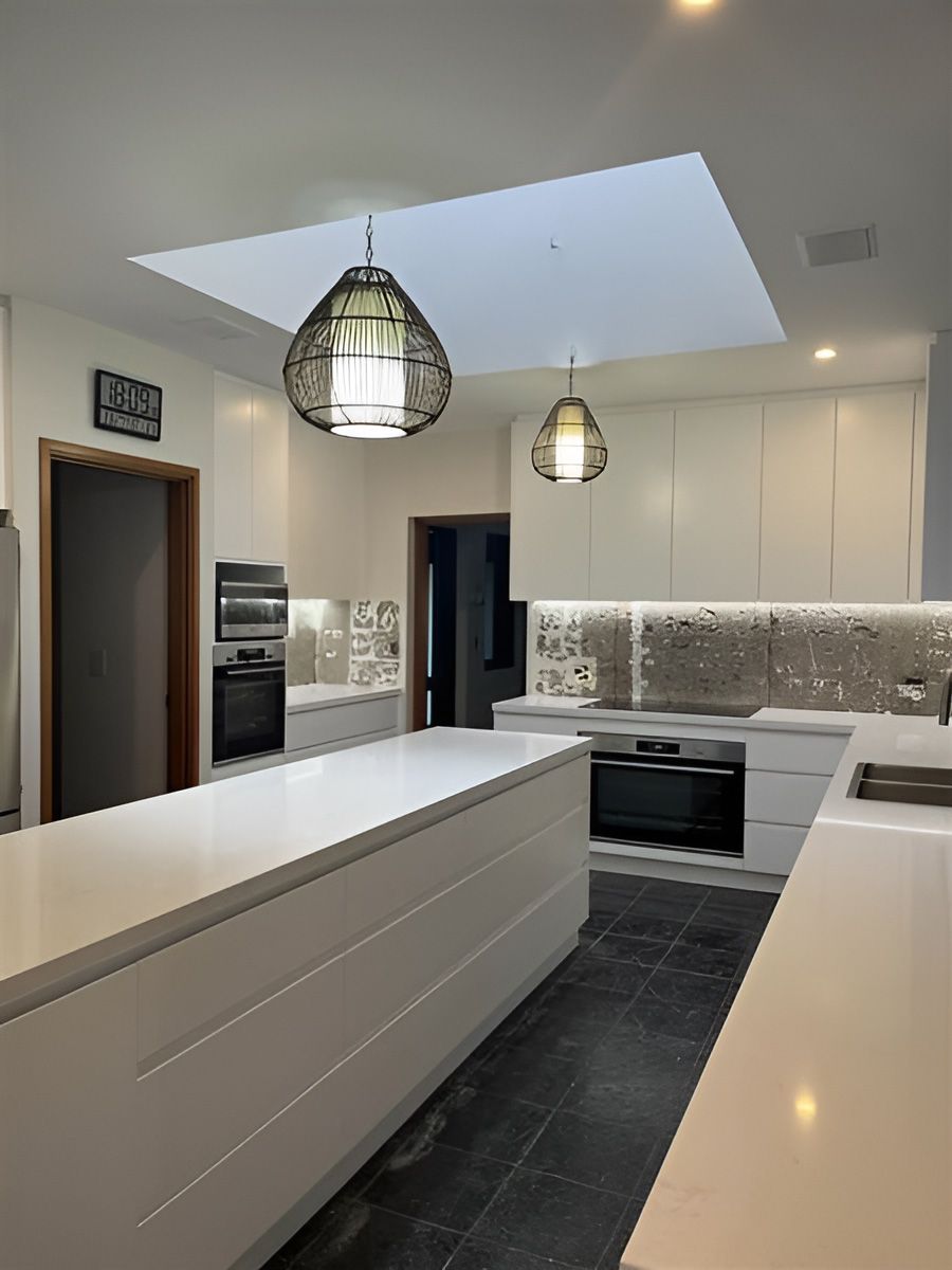 Kitchen With Cabinetry, Large Island, and Dark Floor Tiles — Piscopo Kitchens Plus In Old Bar, NSW