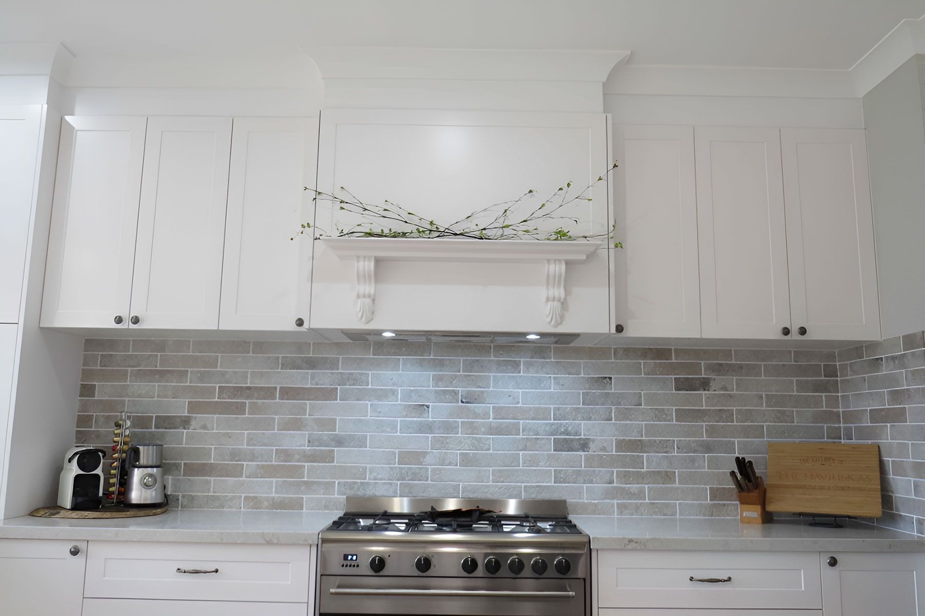 Kitchen With White Cabinets and a Grey Brick Backsplash — Piscopo Kitchens Plus In Forster, NSW