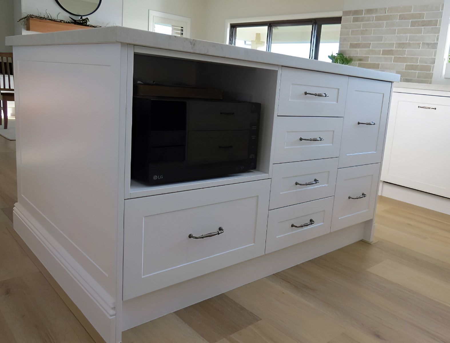 White Kitchen Island With a Marble Countertop — Piscopo Kitchens Plus In Forster, NSW