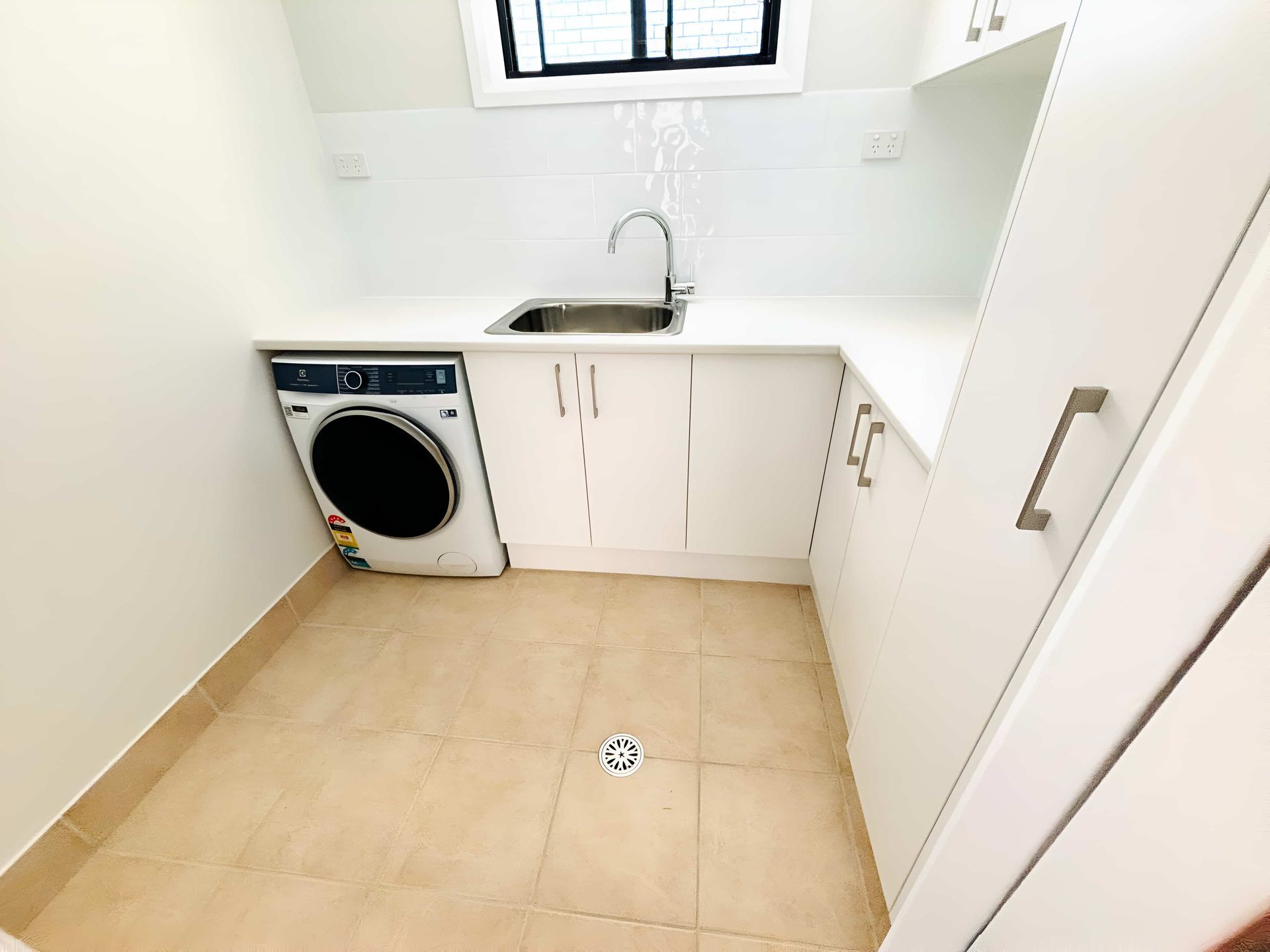 Laundry Room With Beige Tiled Floor — Piscopo Kitchens Plus In Forster, NSW