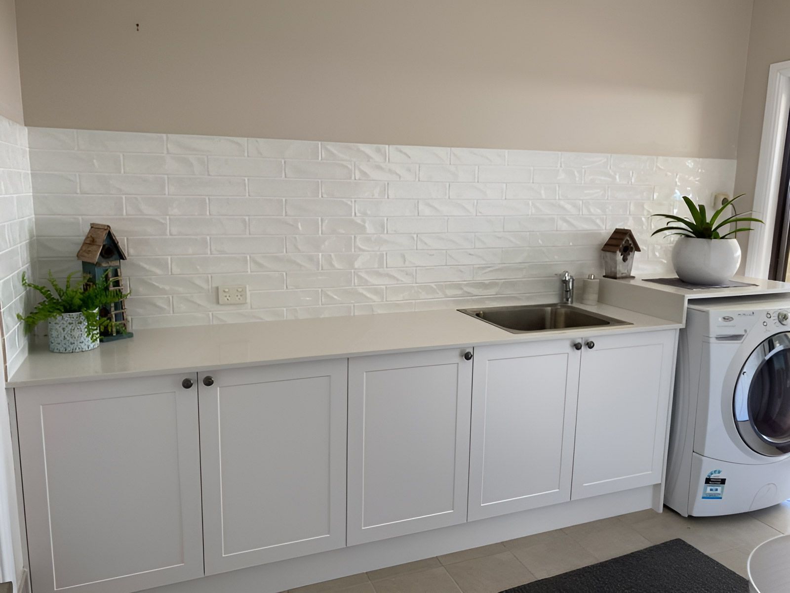A Laundry Room With a Washer and a Sink — Piscopo Kitchens Plus In Tuncurry, NSW
