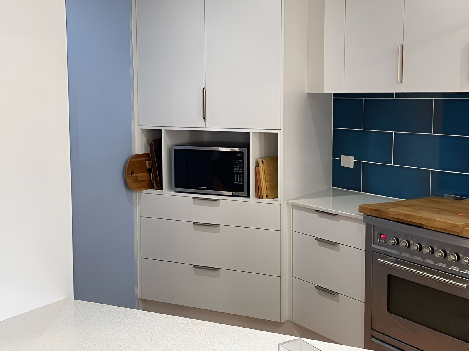 Modern Kitchen Corner With White Cabinets — Piscopo Kitchens Plus In Forster, NSW