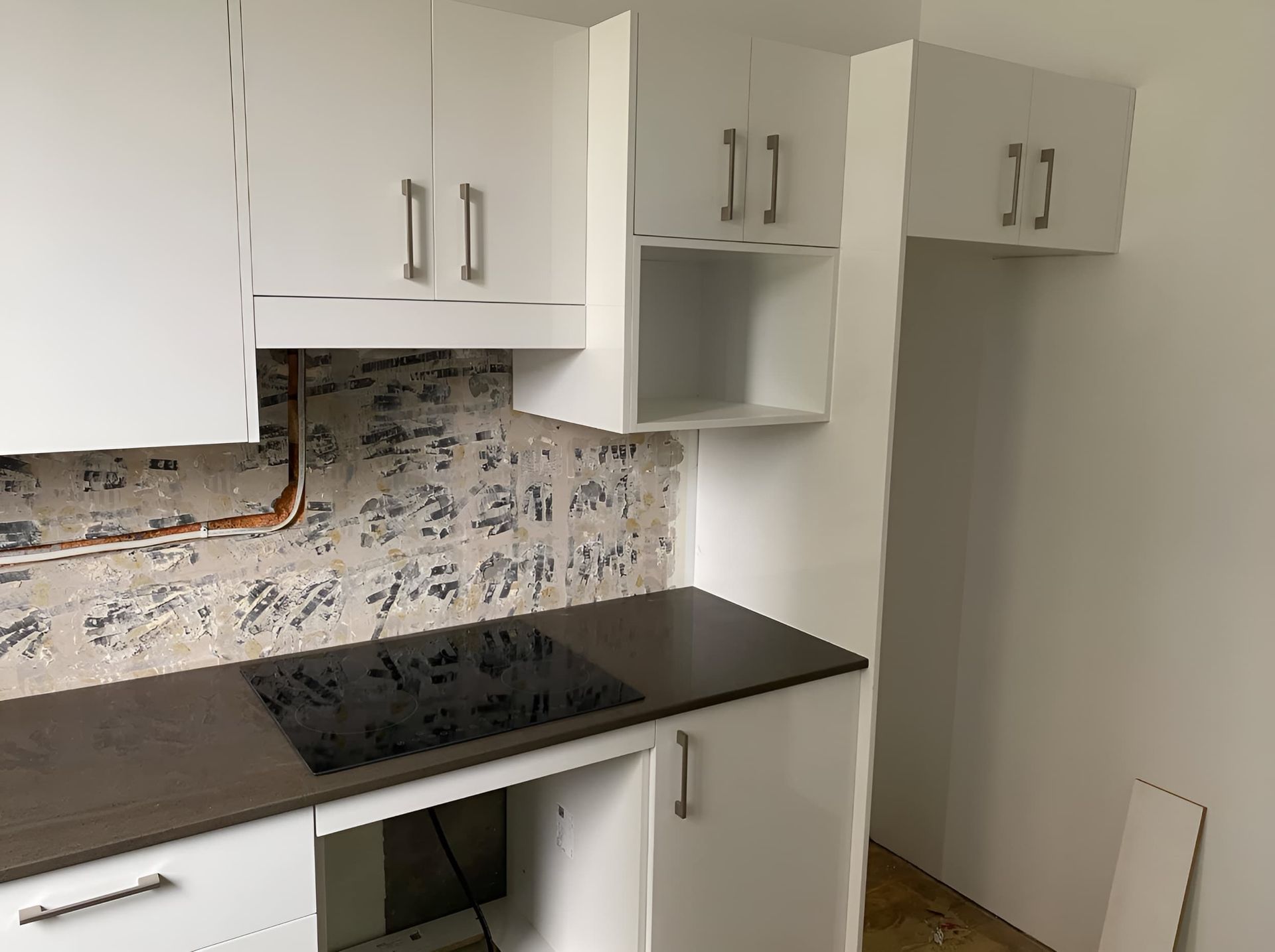A Modern Kitchen With White Cabinets and Silver Handles — Piscopo Kitchens Plus In Forster, NSW