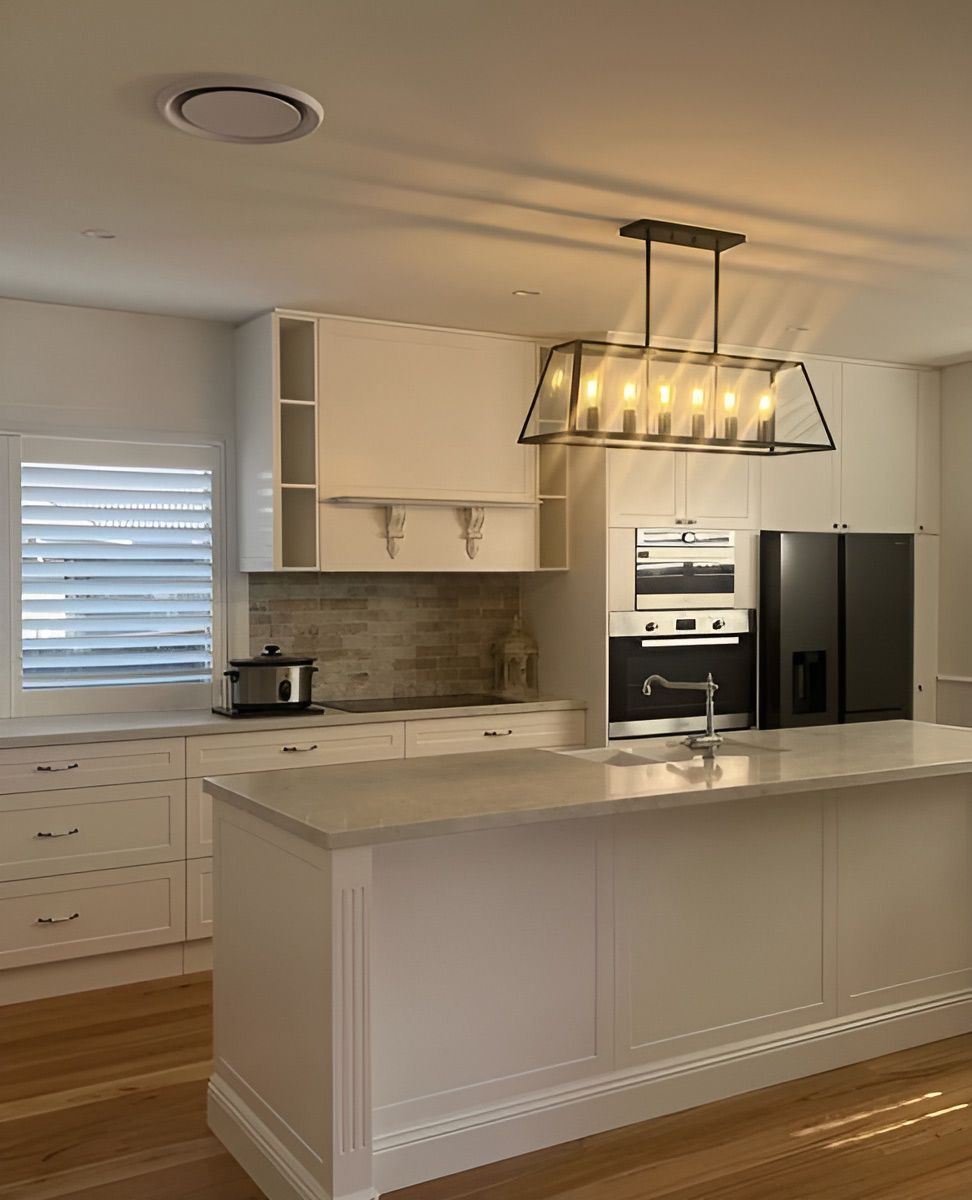 Kitchen With White Cabinetry and a Marble Island — Piscopo Kitchens Plus In Forster, NSW