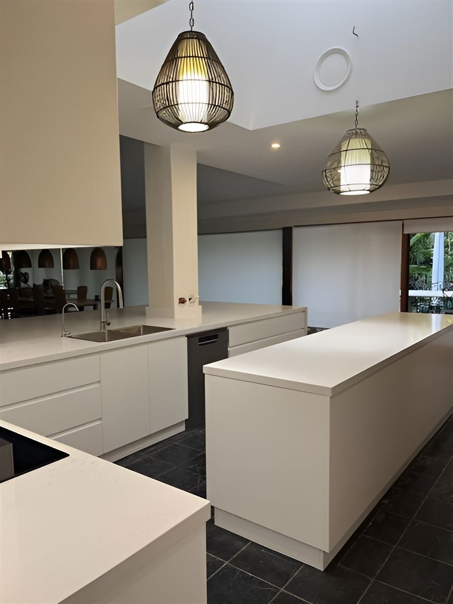 Kitchen With Sleek White Countertops and Cabinets — Piscopo Kitchens Plus In Forster, NSW