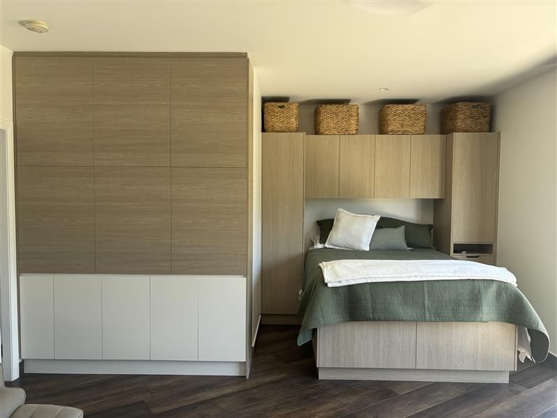 Modern bedroom with a bed and built-in wardrobe — Piscopo Kitchens Plus In Forster, NSW