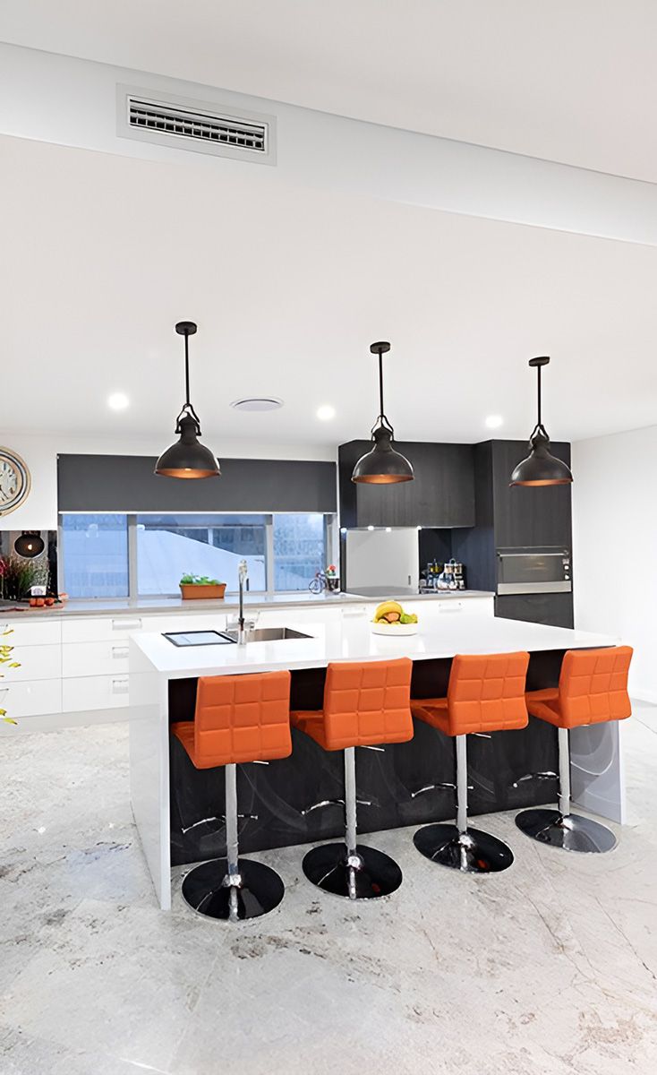 Modern Kitchen With a White Island and Four Orange Bar Stools — Piscopo Kitchens Plus In Forster, NSW
