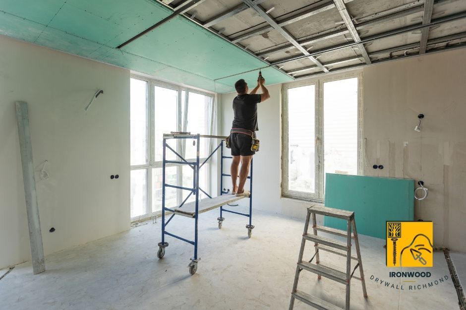 A drywall contractor is about to hang sheetrock in Richmond, BC, West Cambie, showcasing the drywall installation process.