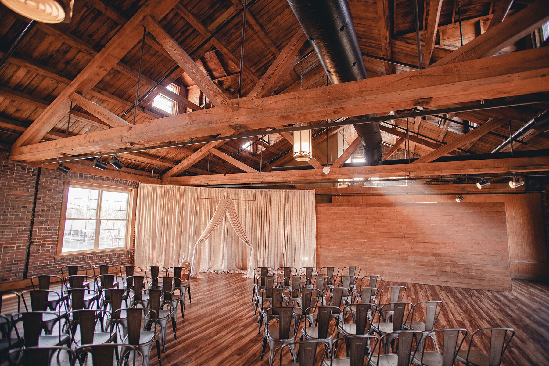 wedding venue with exposed wooden beams and brick walls