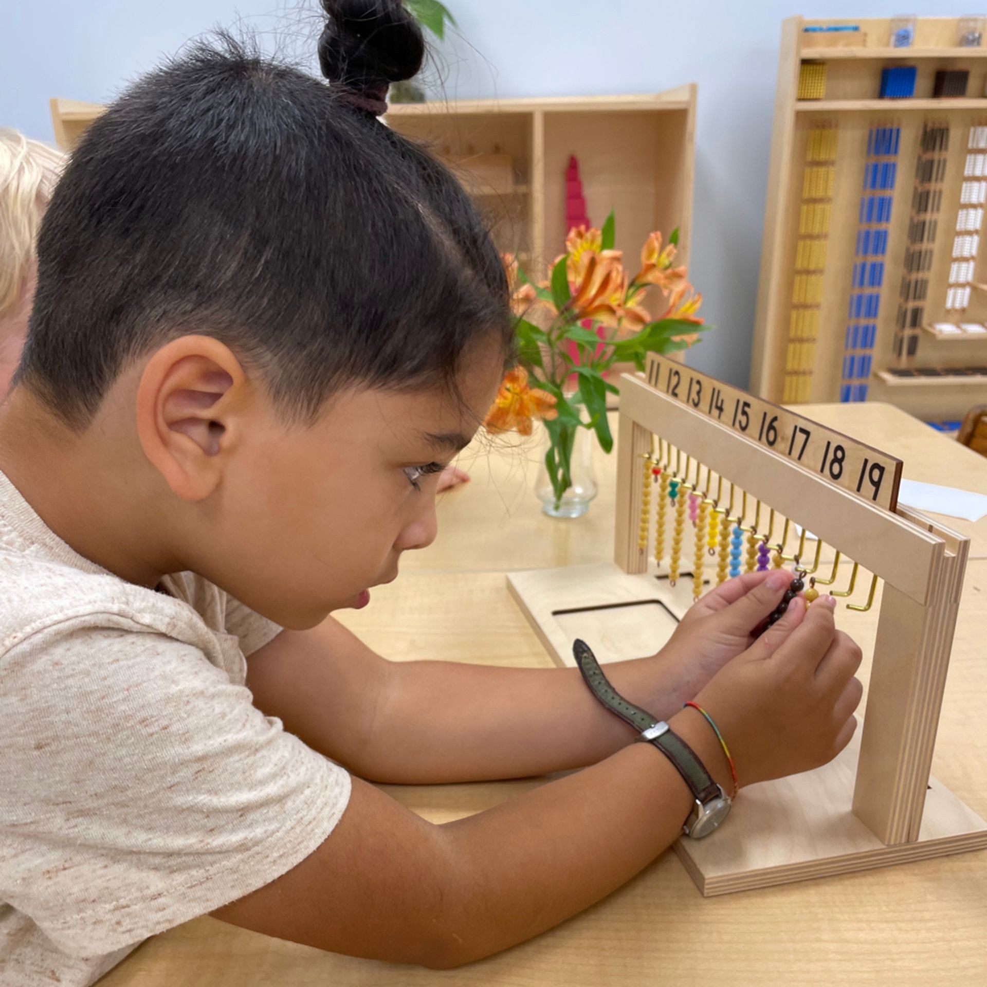 a Montessori childi s playing with a wooden toy