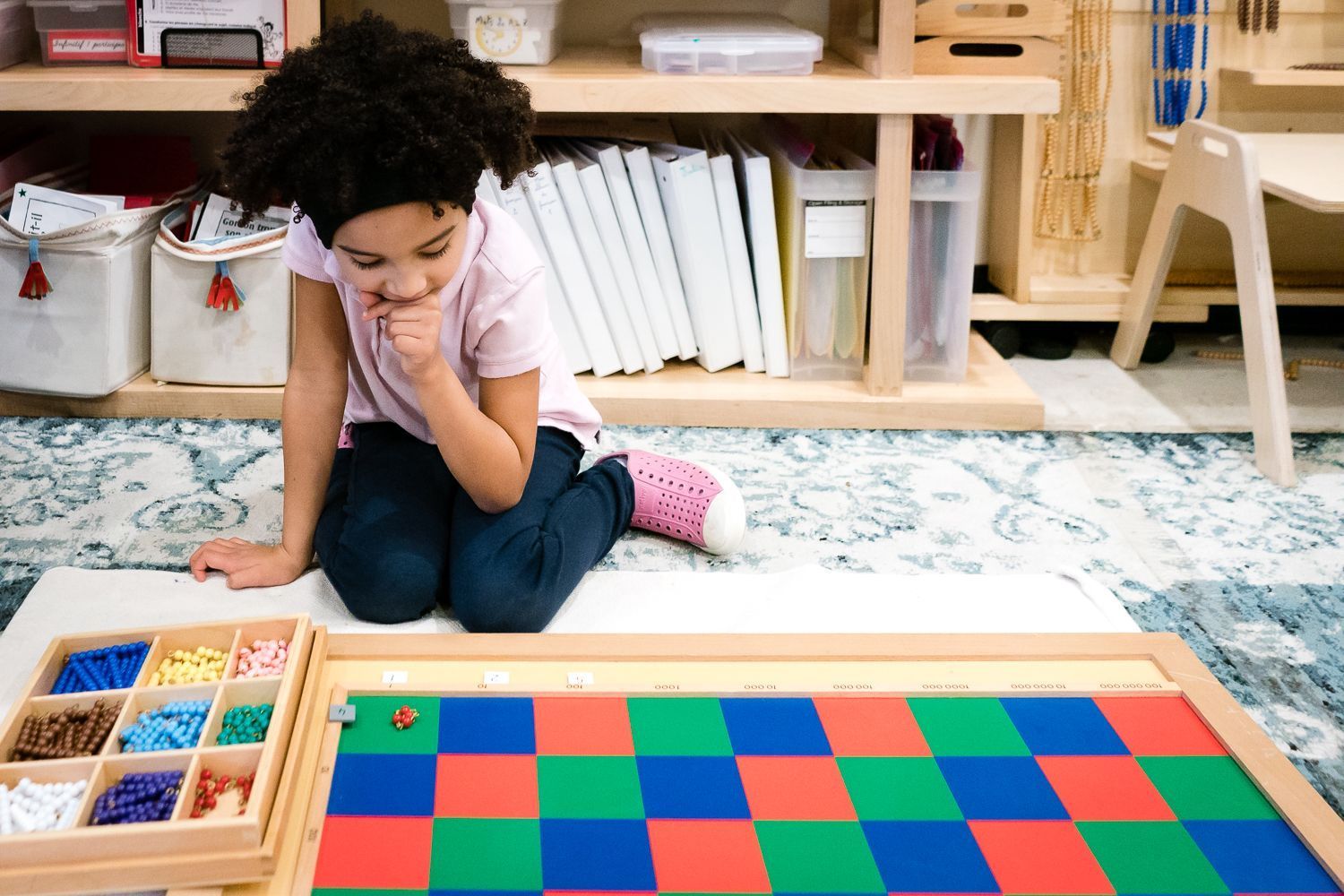 Montessori elementary student working on materials