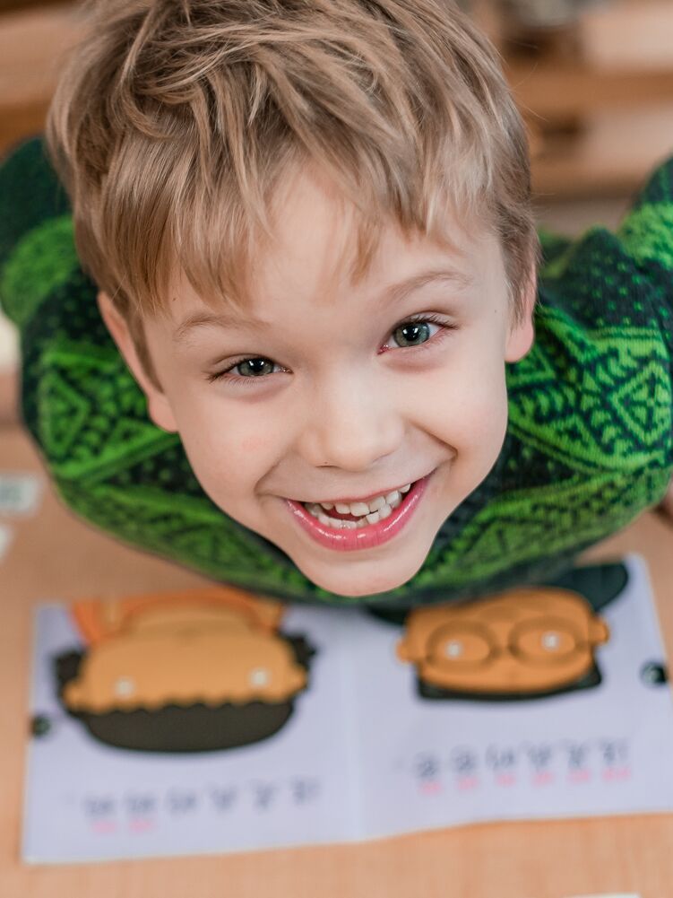 Montessori child smiling at camera