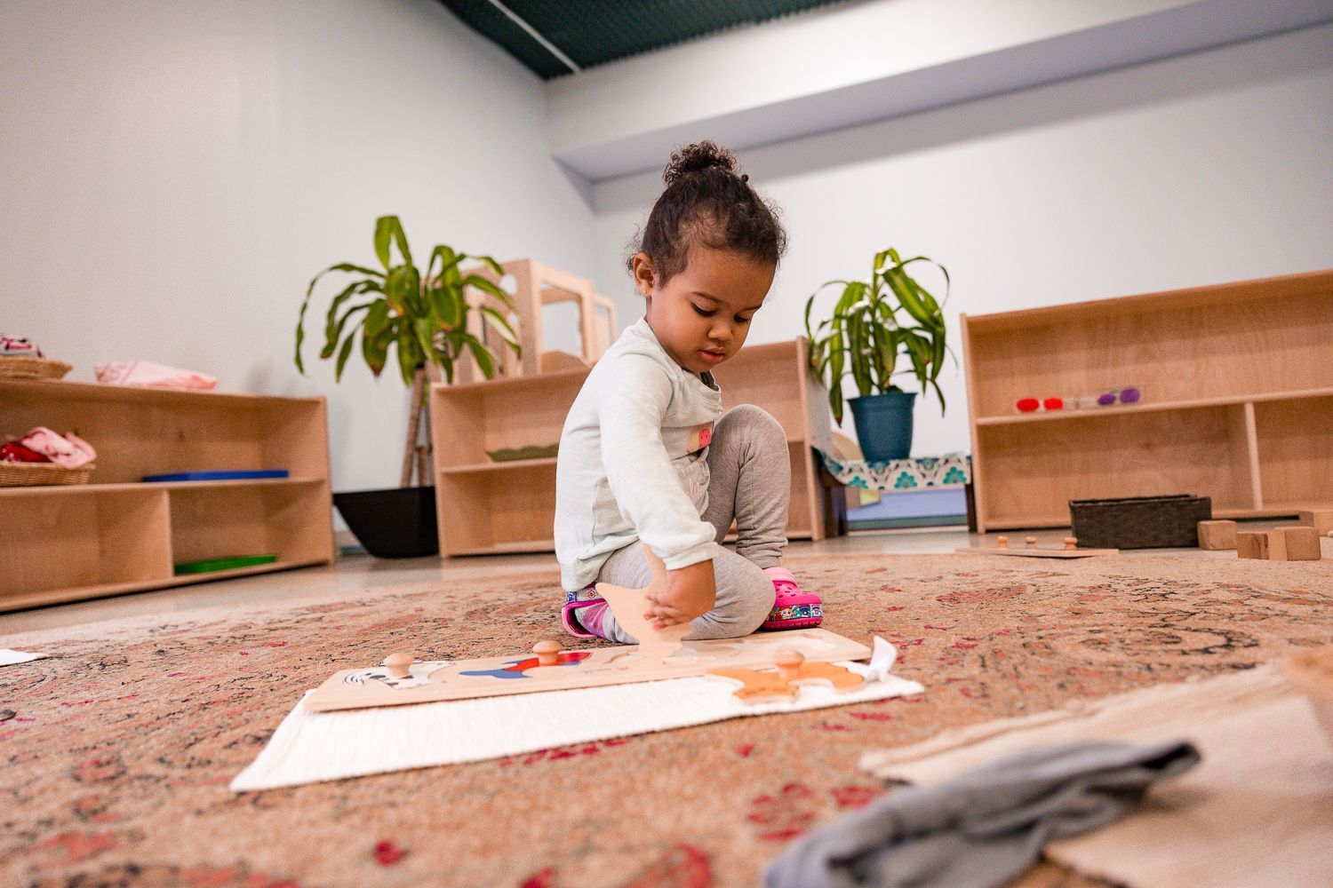 Toddler working on Montessori materials