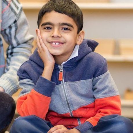 Montessori child sitting in classroom