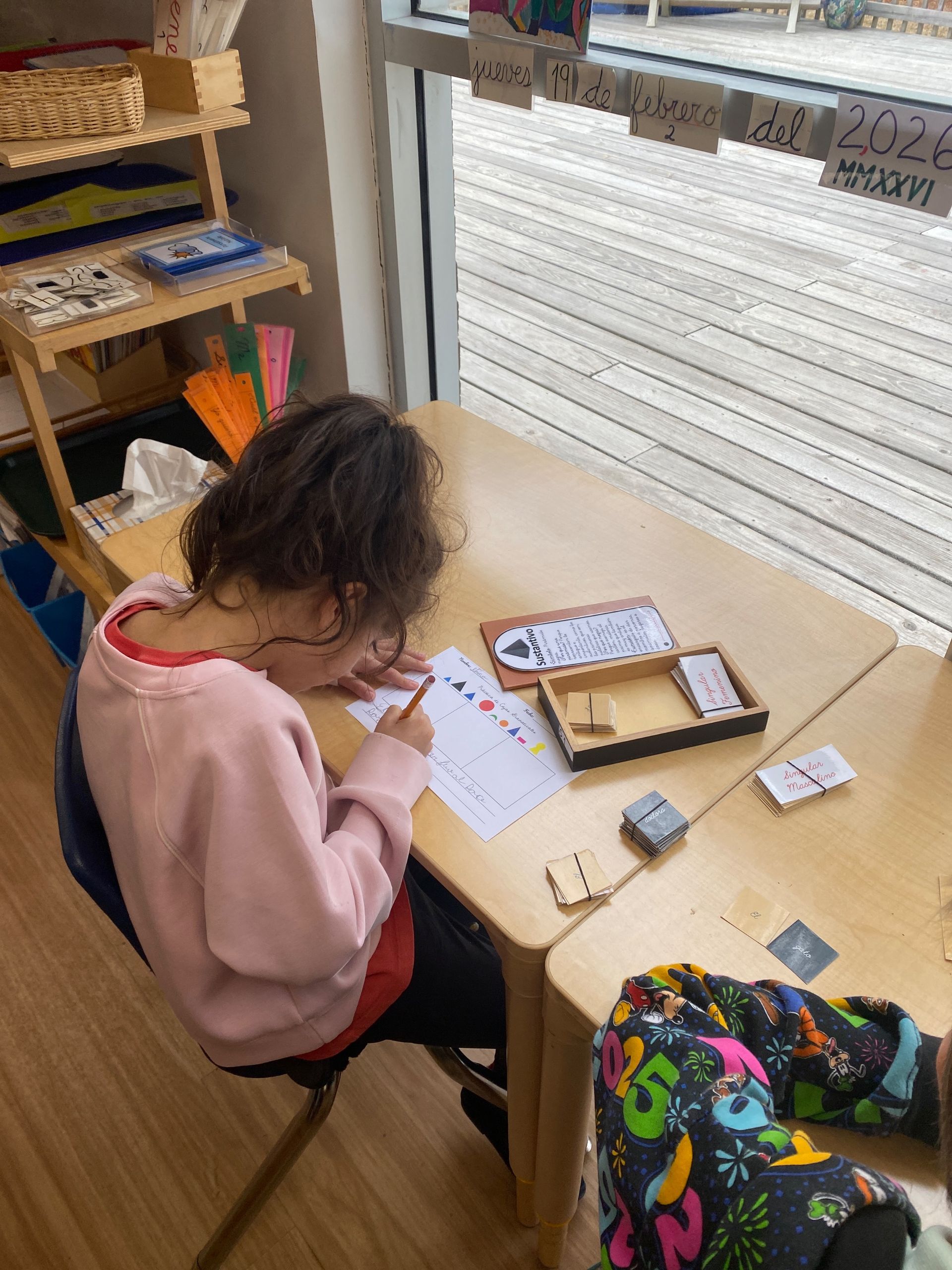 Montessori children working on reports