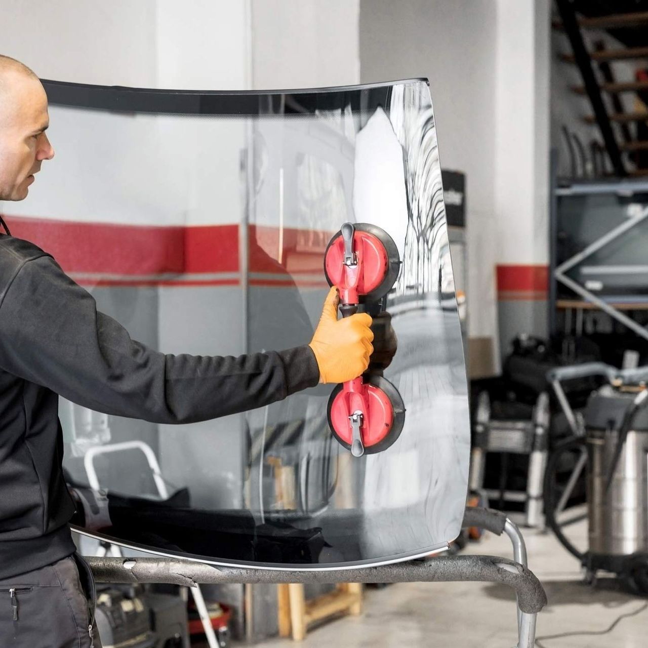 Man holding windshield up in the air — San Antonio, TX — Rockguard Autoglass