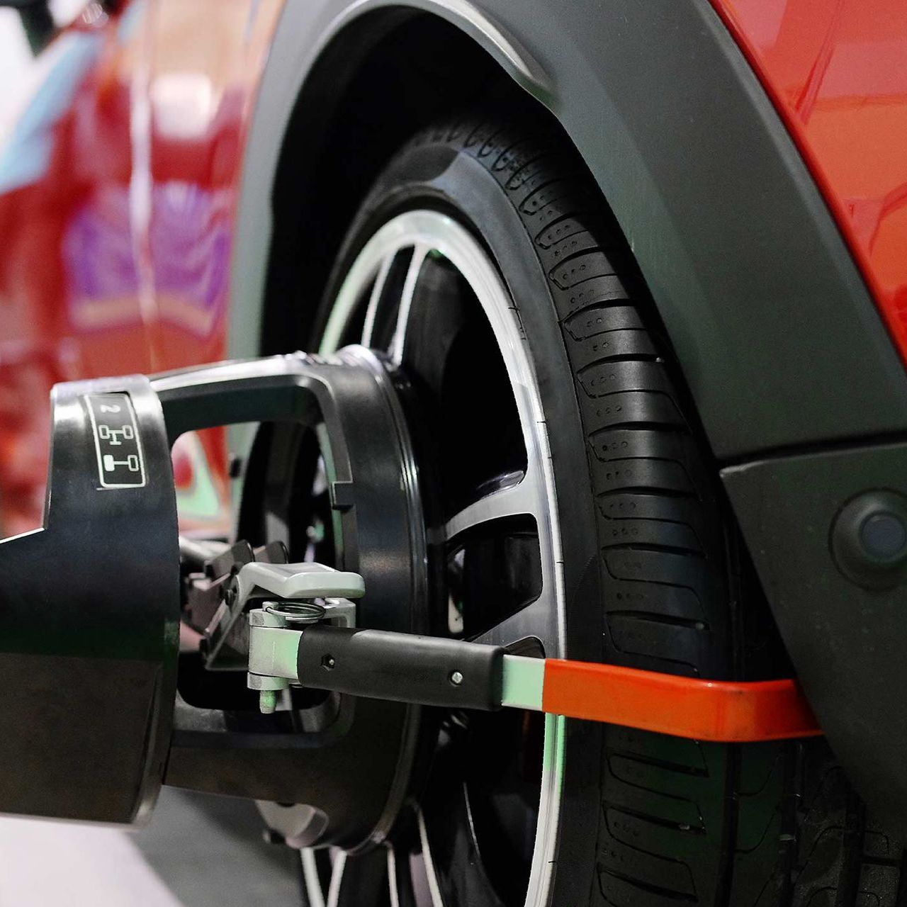 Wheel alignment equipment on a car wheel — San Antonio, TX — Rockguard Autoglass Wheel alignment equipment on a car wheel — San Antonio, TX — Rockguard Autoglass