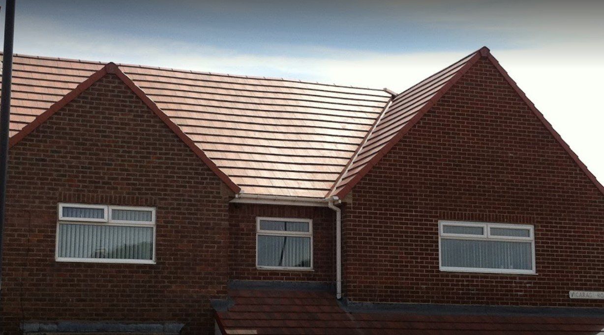 A picture of a red concrete tile roof installed by Roofers Birmingham