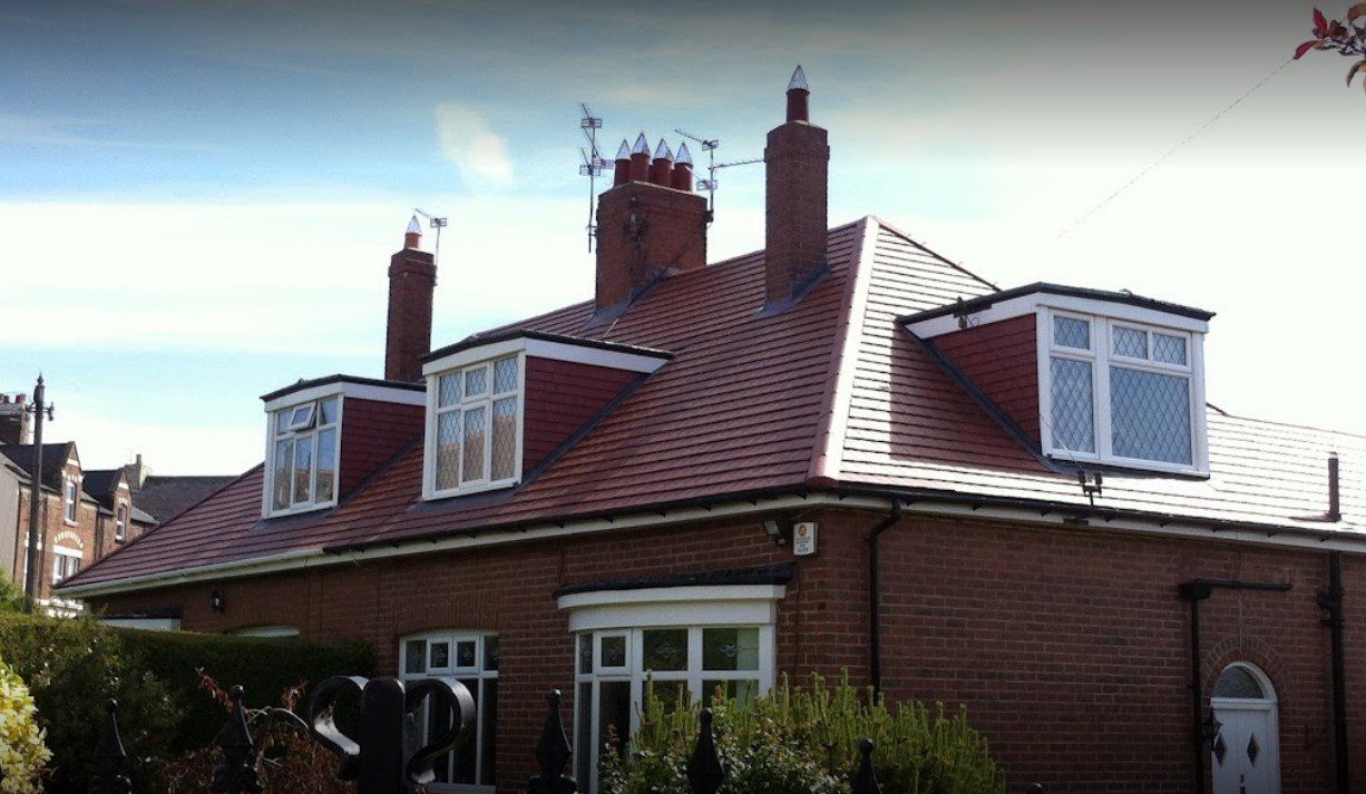 A picture of a red clay tile dormer roof installed by roofers Birmingham