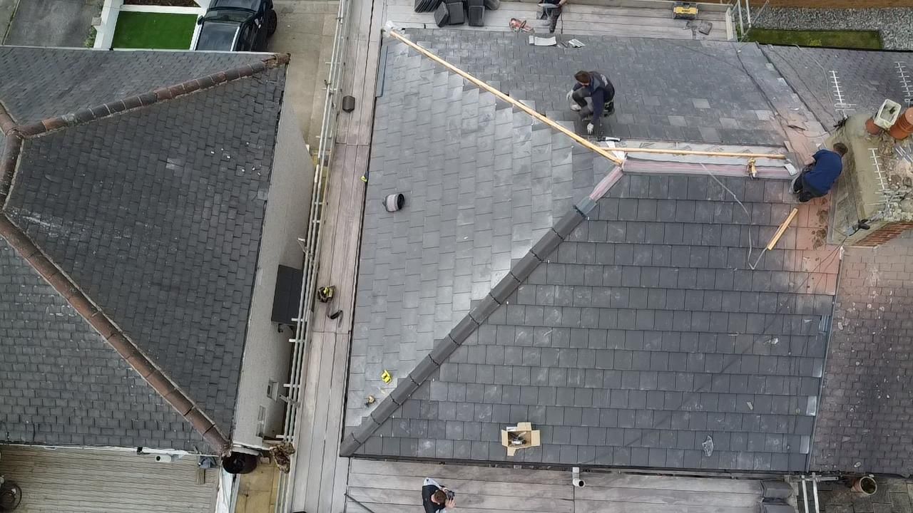 Roofers Birmingham - our roofers in Birmingham working on a semi detached hip roof
