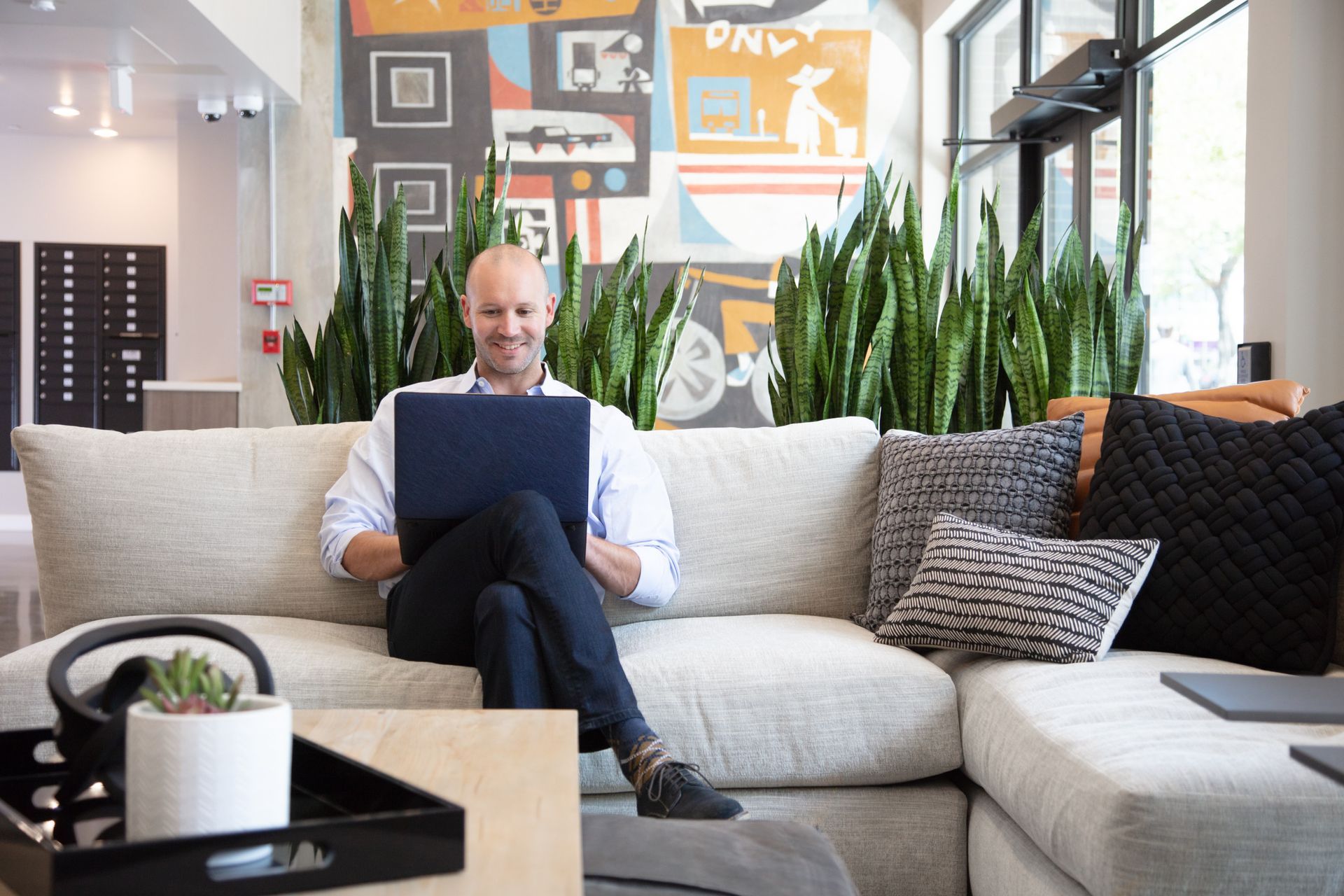 777 broadway lobby person on laptop