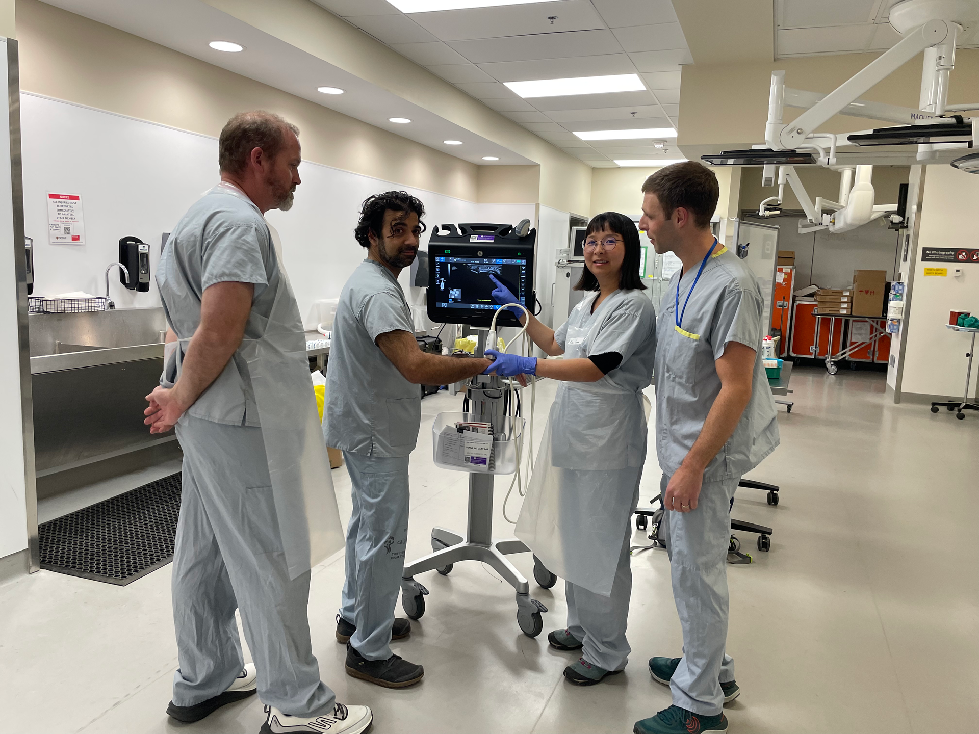 Medical team reviewing an ultrasound scan in a hospital room