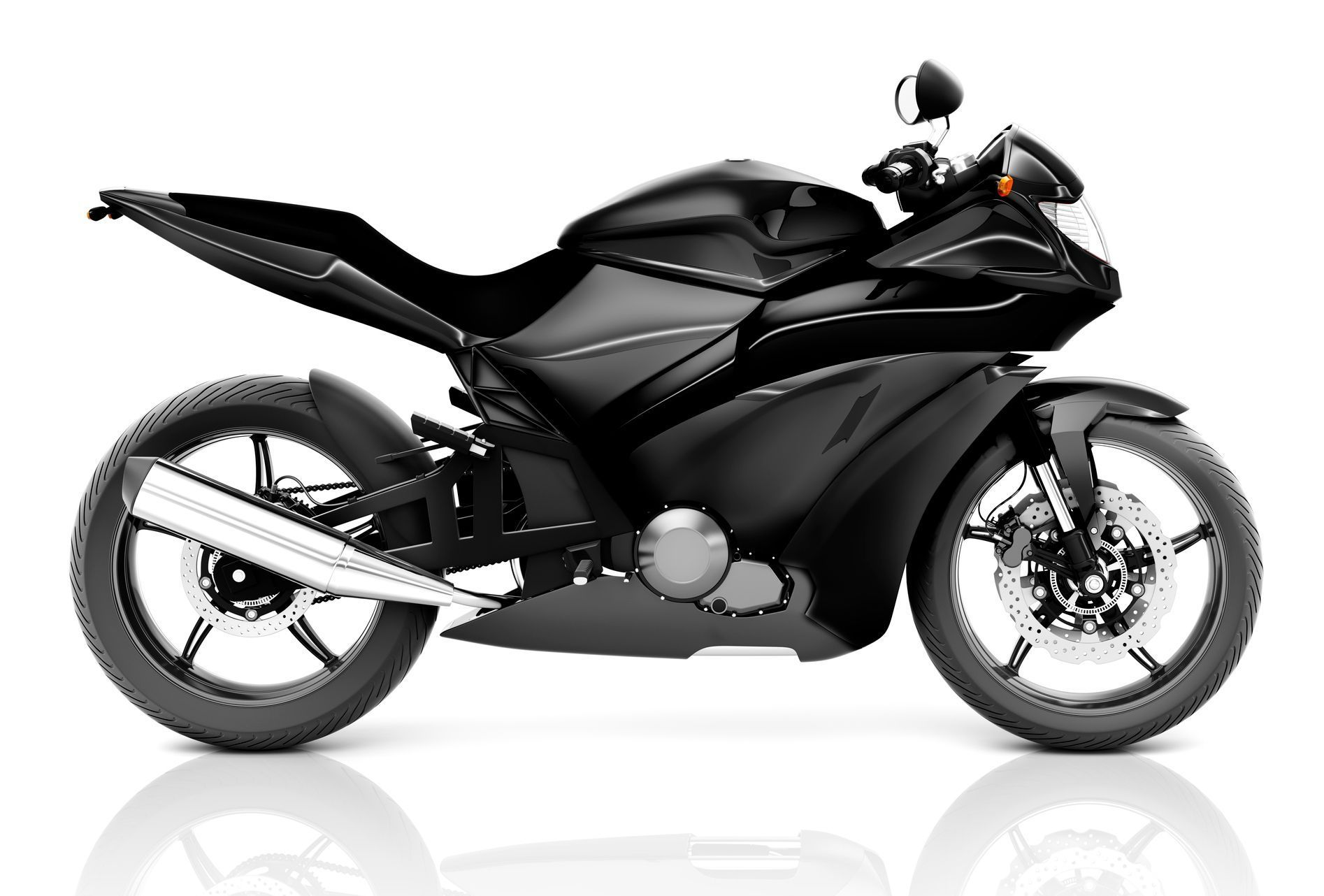A black motorcycle is sitting on a white surface.