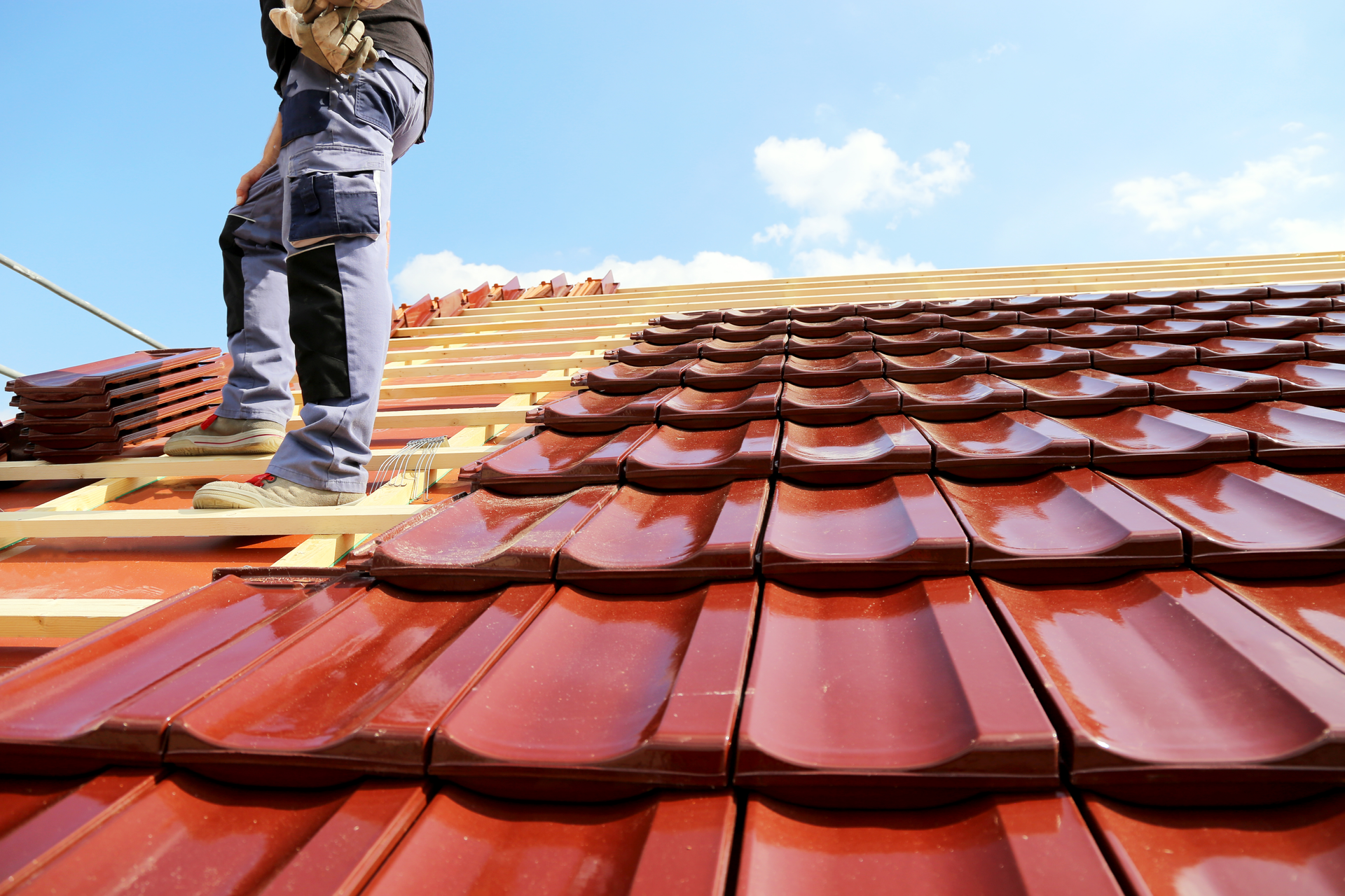 A Roofing contractor working on a residential roofing system maintenance in Marlton, NJ; service pro