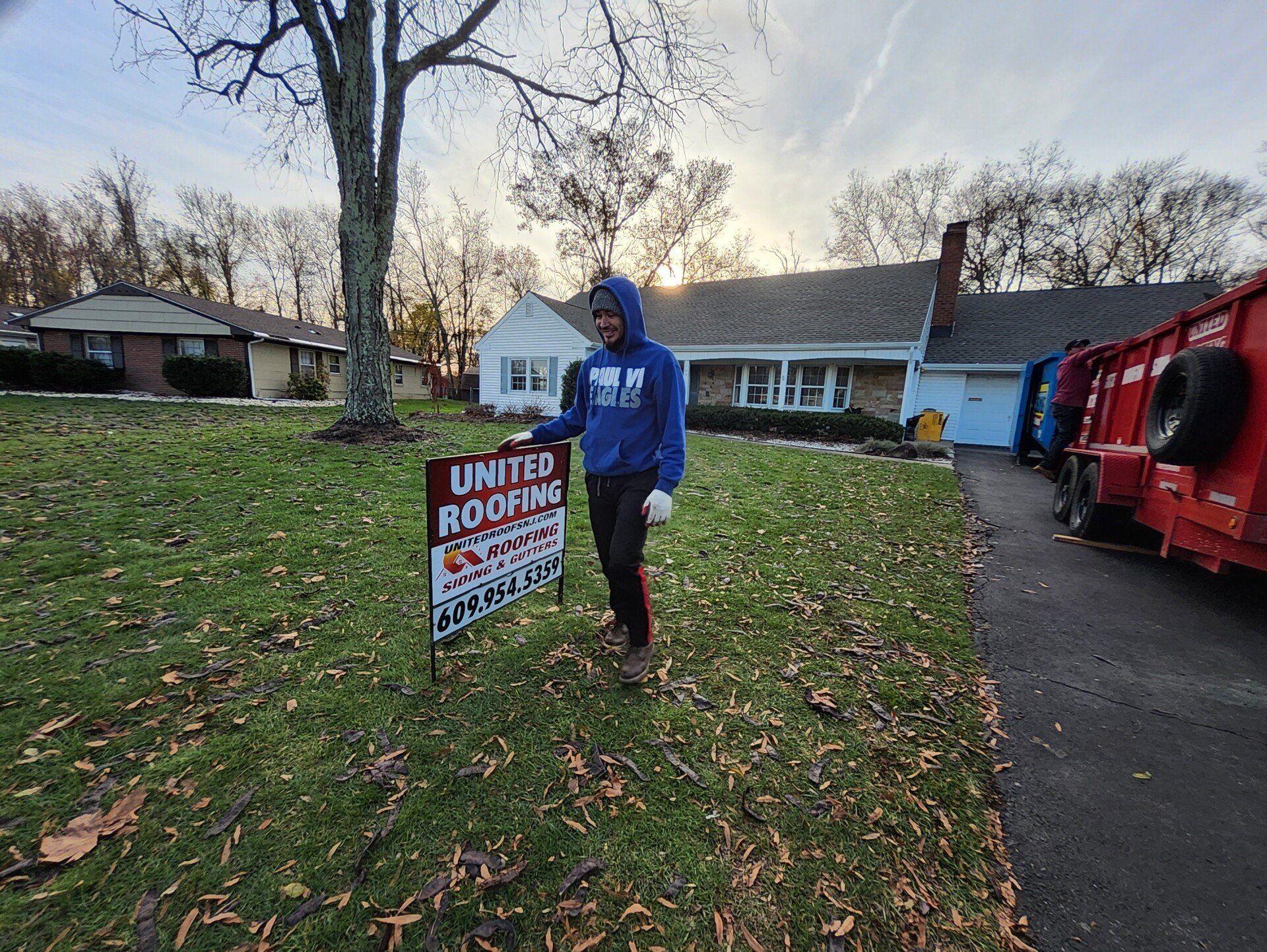 Person in blue hoodie holding a