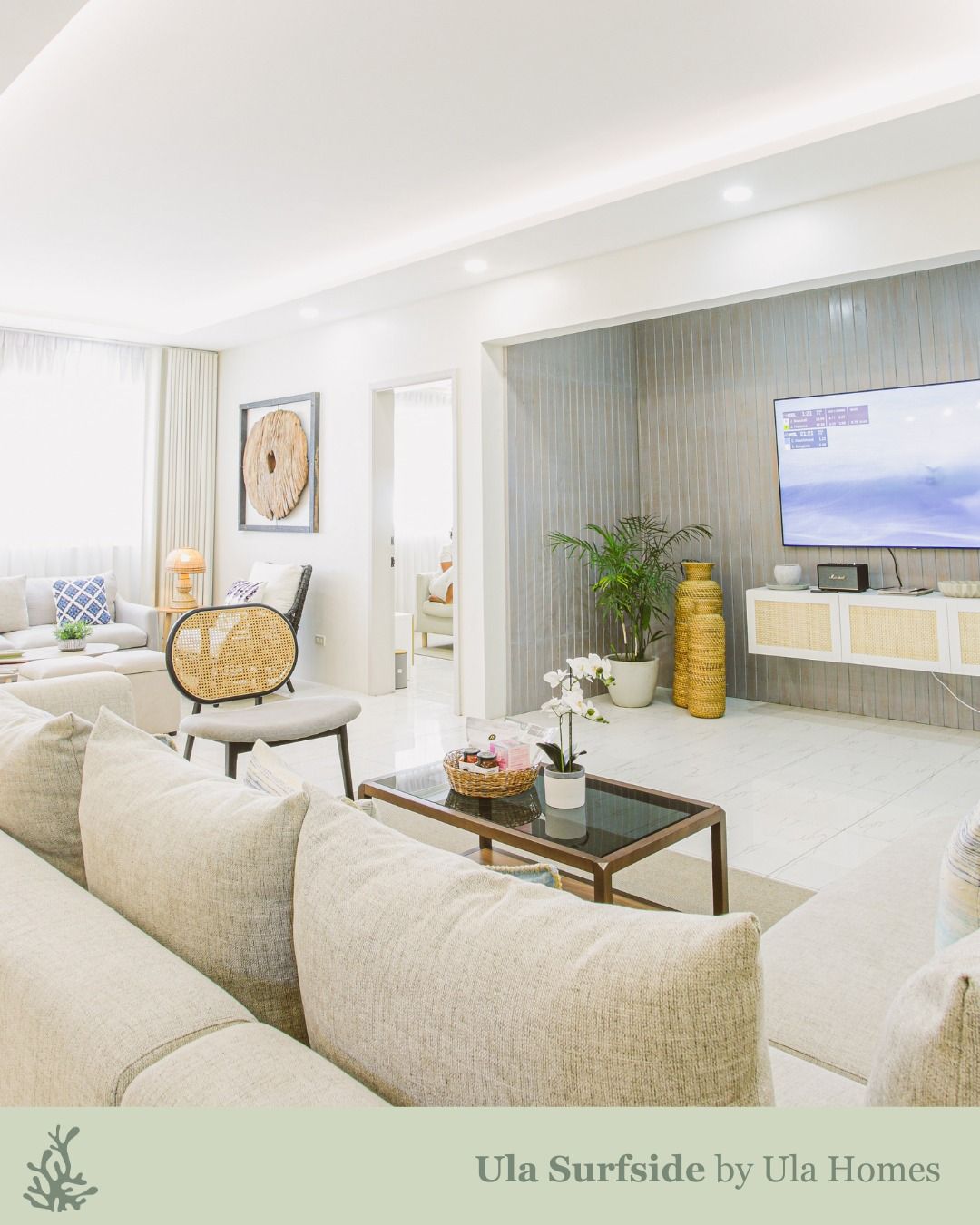 Living room interior with beige sofa, TV, and decorative items.