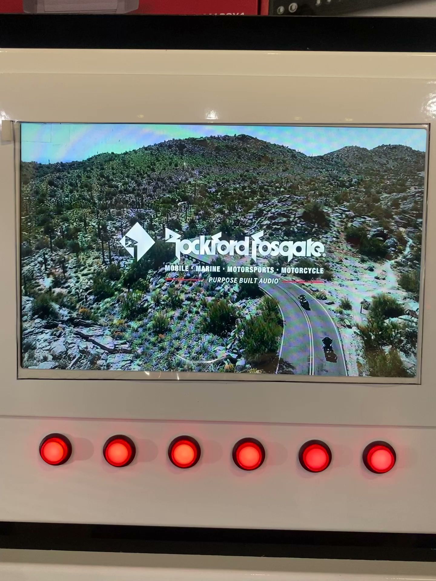 Rockford Fosgate display on a screen above six red indicator buttons