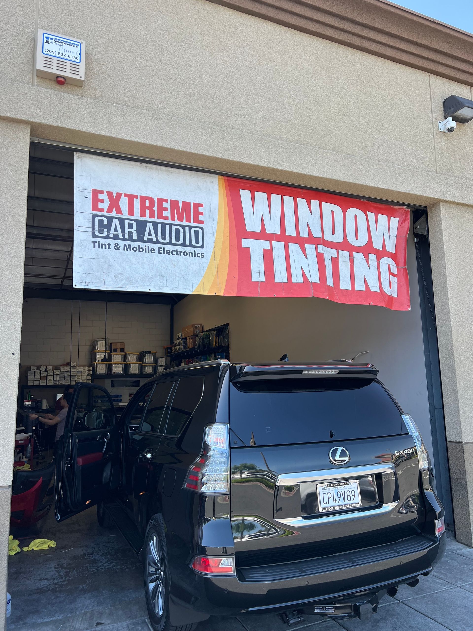 Black SUV parked outside Extreme Car Audio and Window Tinting shop