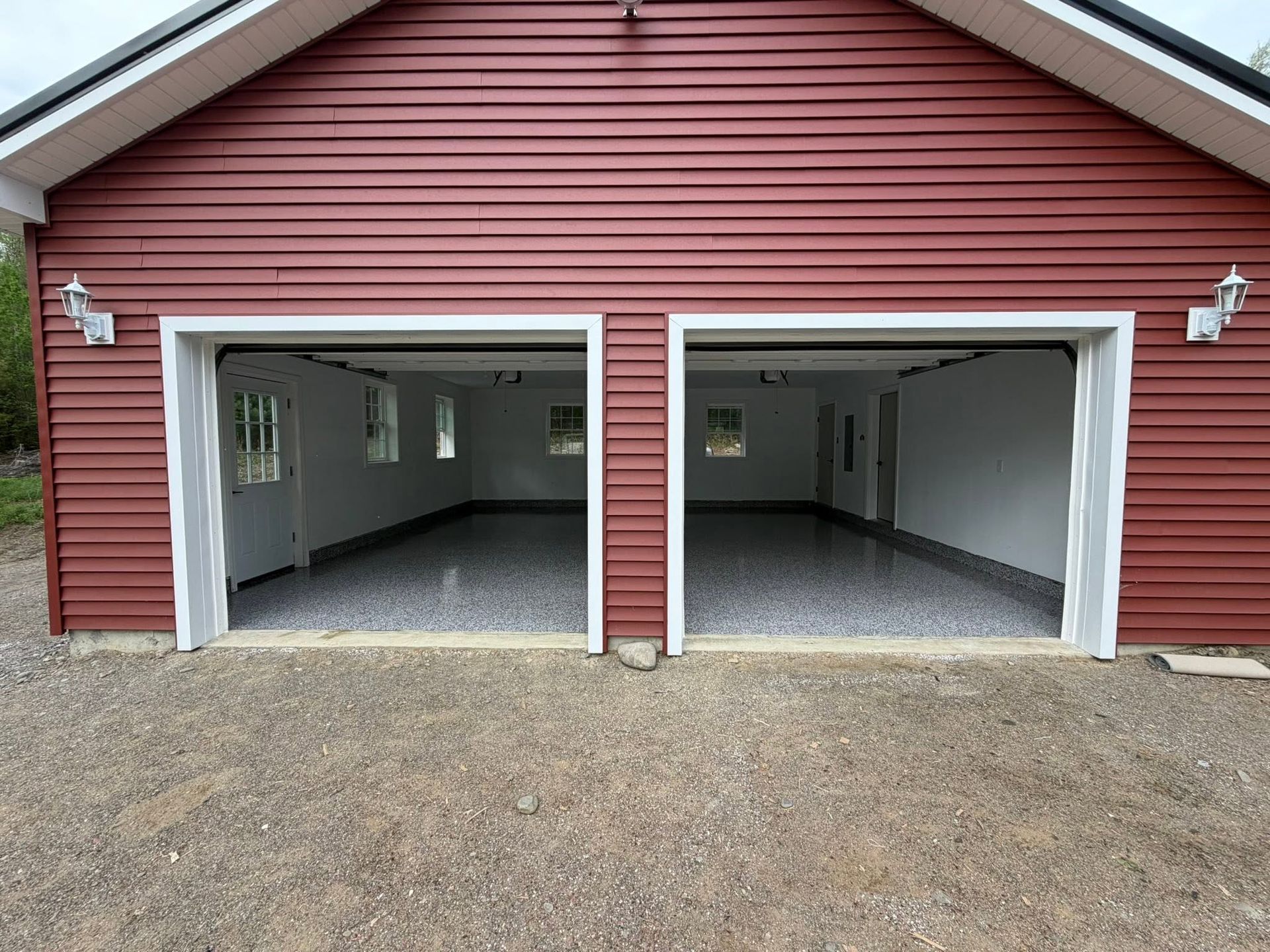 garage with red siding and a finished epoxy floor