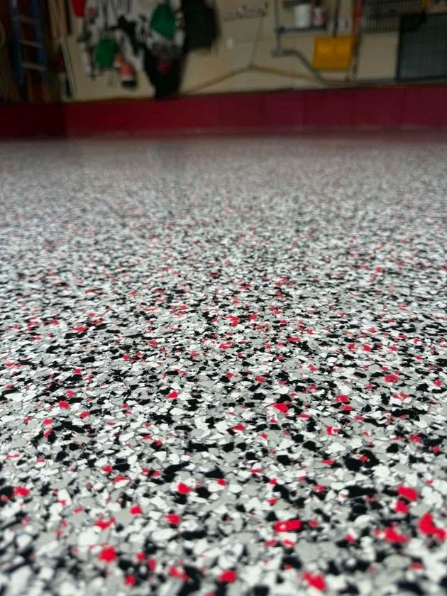Shiny gray industrial floor with yellow stripe, open hangar interior, overhead lights.