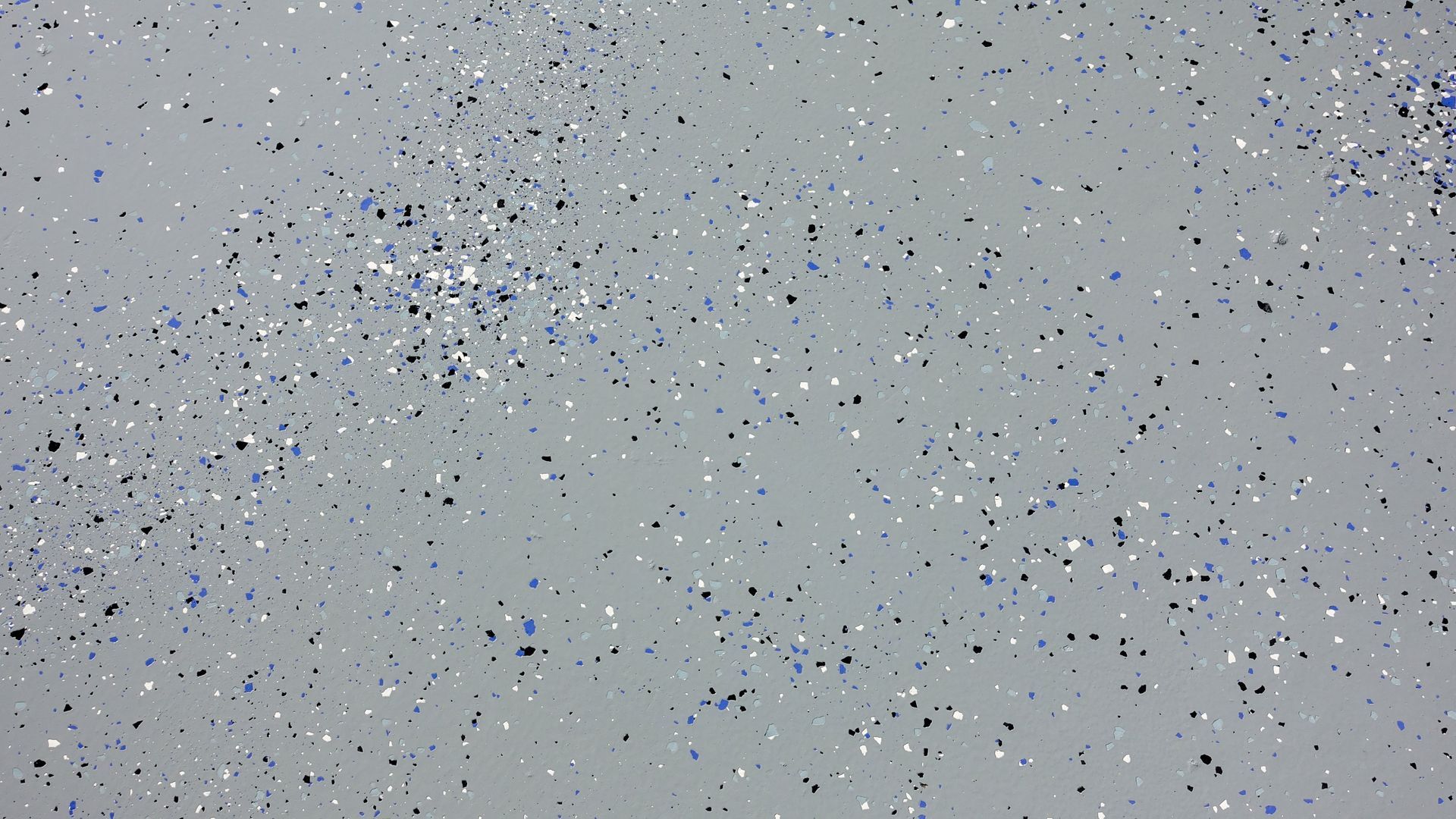 Gray floor speckled with black, white, and blue chips.