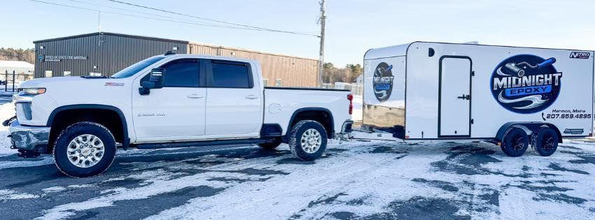 White pickup truck towing a trailer with