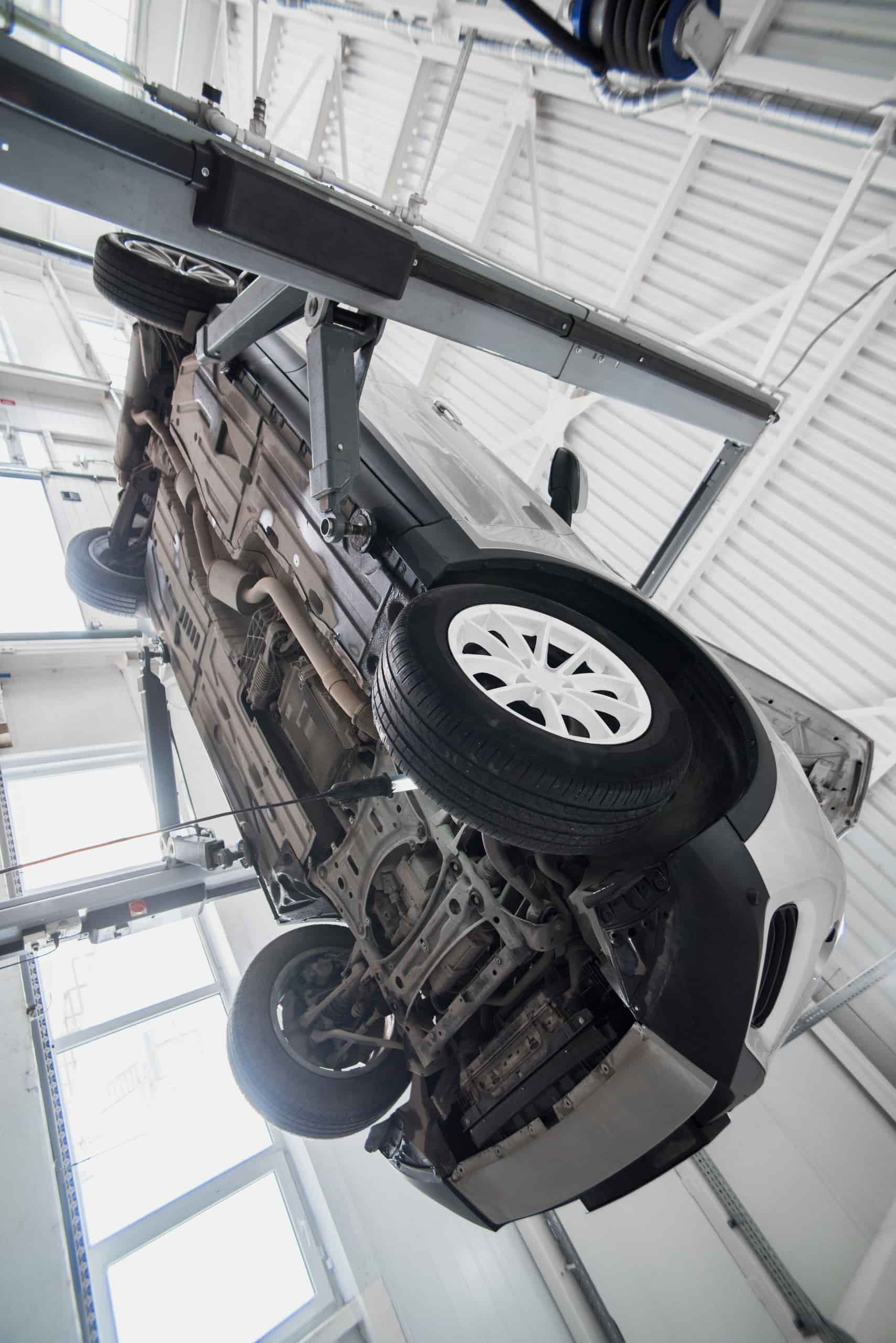 A Car Lifted on a Hydraulic Hoist — Berkeley Vale Tyre & Mechanical in Fountaindale, NSW