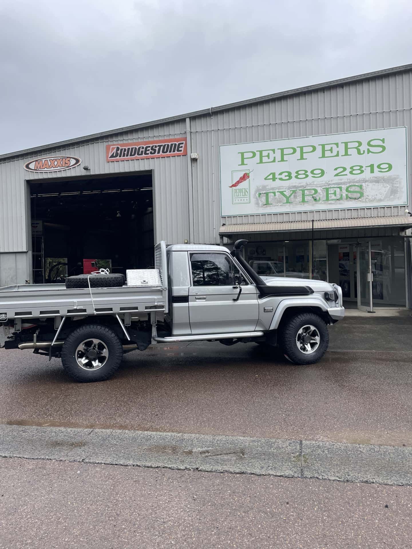 A Silver Utility Truck Parked in Front of Peppers Tyres — Berkeley Vale Tyre & Mechanical in Fountaindale, NSW