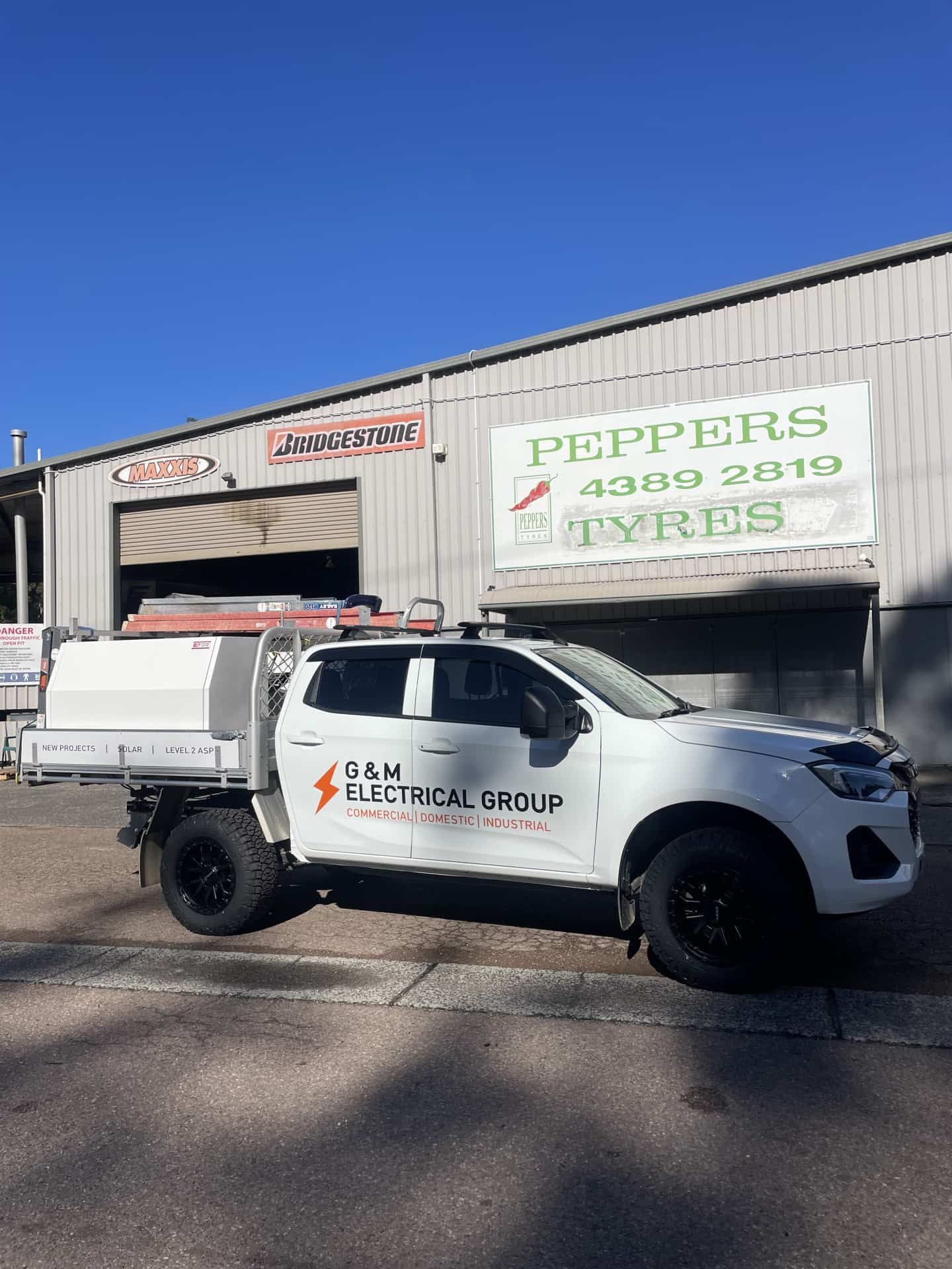 A White G&m Electrical Group Utility Vehicle Parked — Berkeley Vale Tyre & Mechanical in Fountaindale, NSW