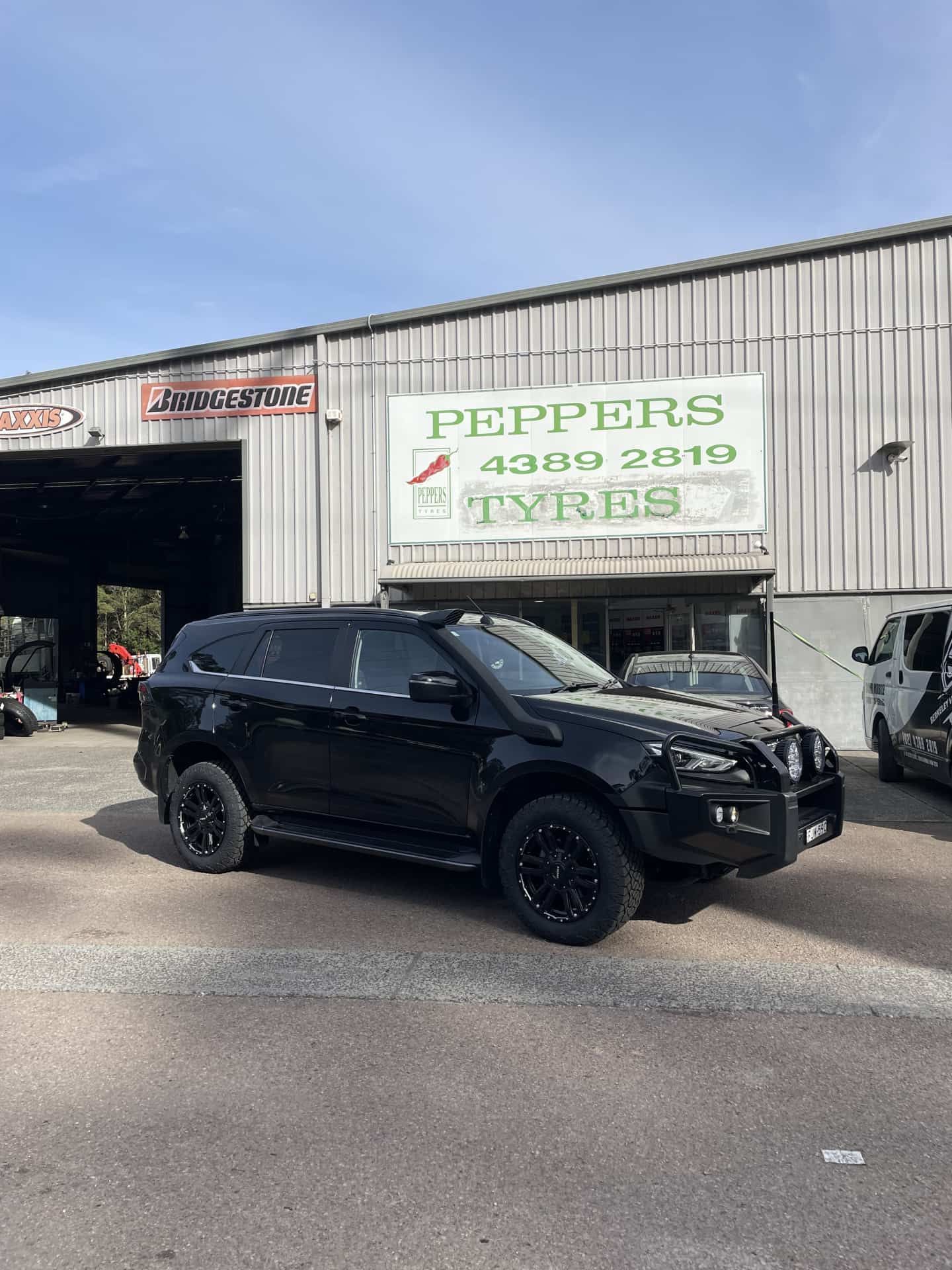 A Black Suv With a Roof Rack and Bull Bar — Berkeley Vale Tyre & Mechanical in Fountaindale, NSW