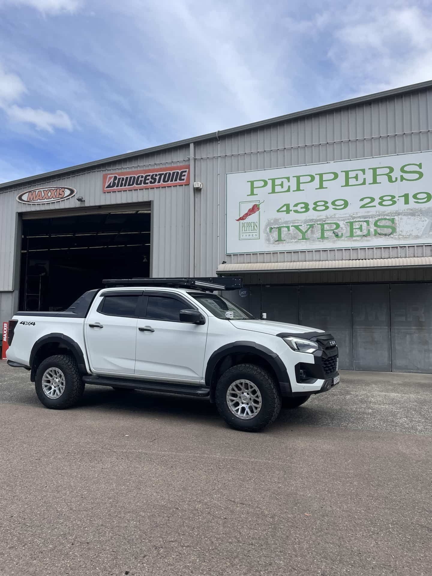 A White Pickup Truck Parked in Front — Berkeley Vale Tyre & Mechanical in Fountaindale, NSW