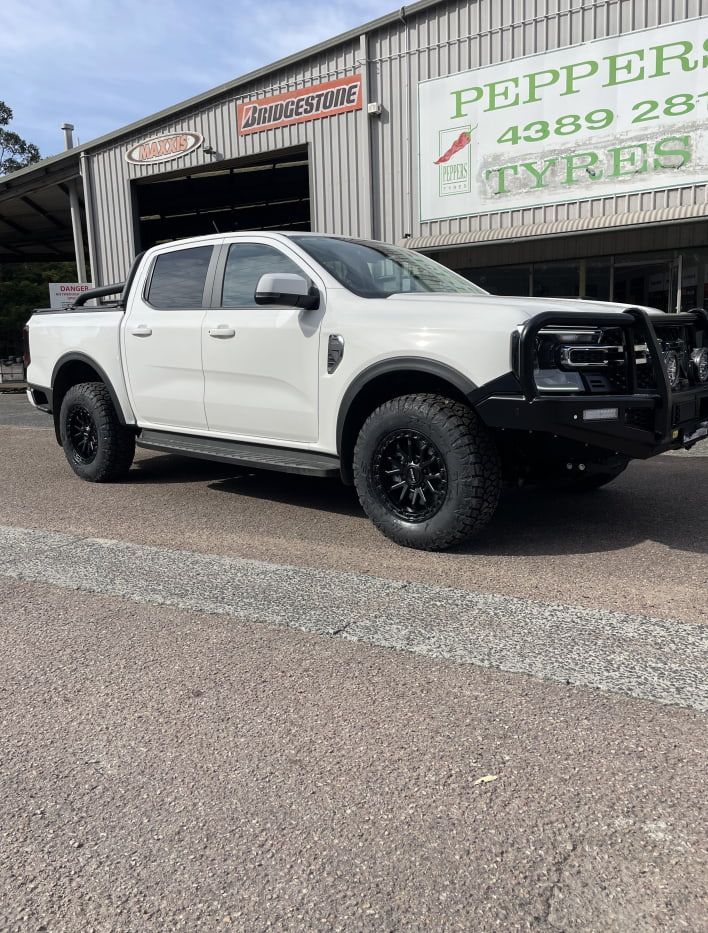 A White Ford Ranger Pickup Truck With a Black Bull Bar — Berkeley Vale Tyre & Mechanical in Fountaindale, NSW