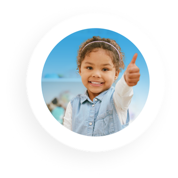 Smiling girl with thumbs up, wearing denim vest. Blue sky background.