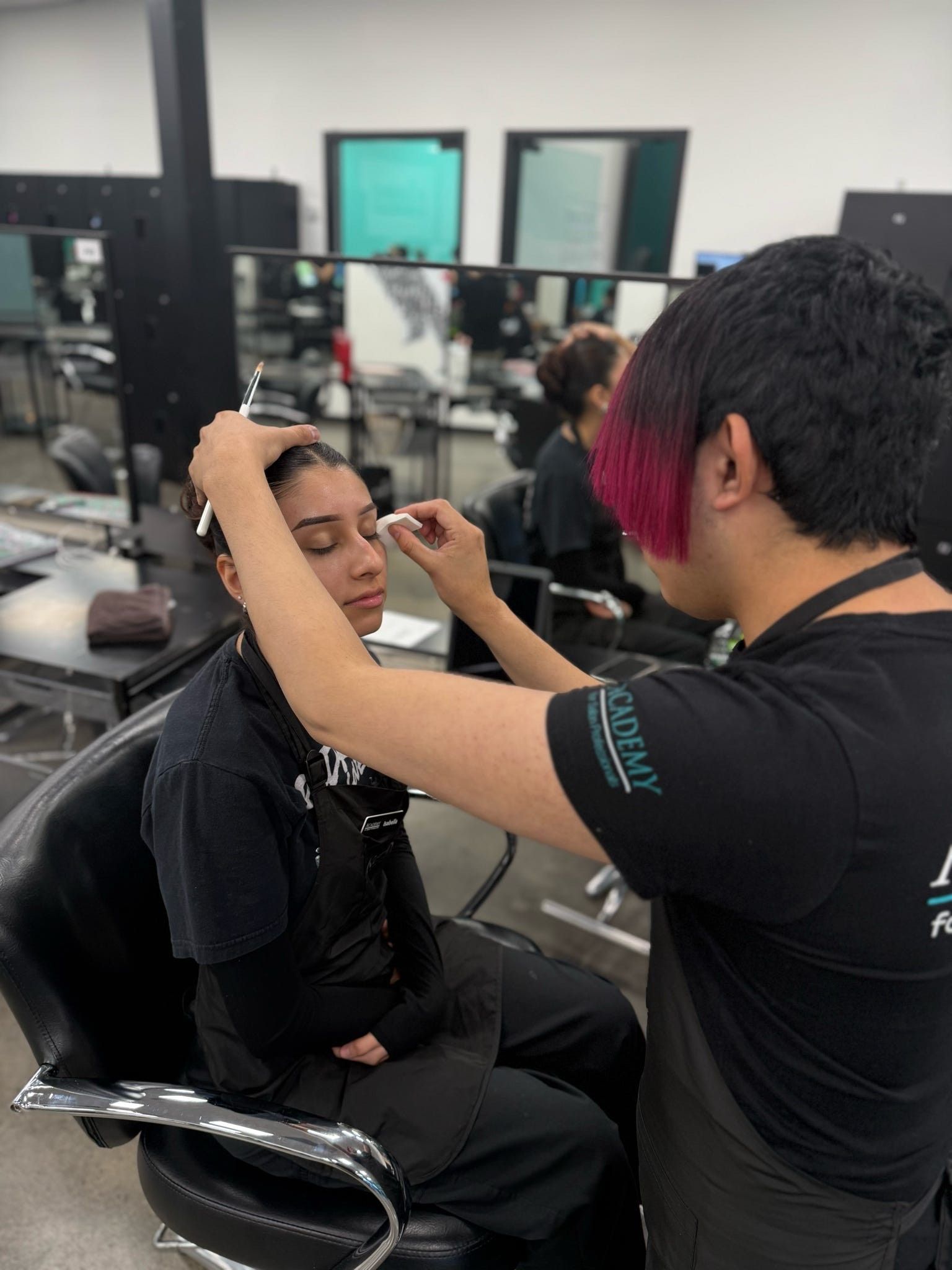 Esthetics student performing a facial treatment