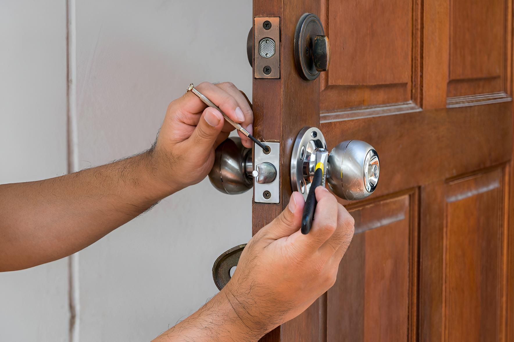Person Doing a Locksmith on Door — Coffs City Lockmart Pty Ltd in Woolgoolga, NSW