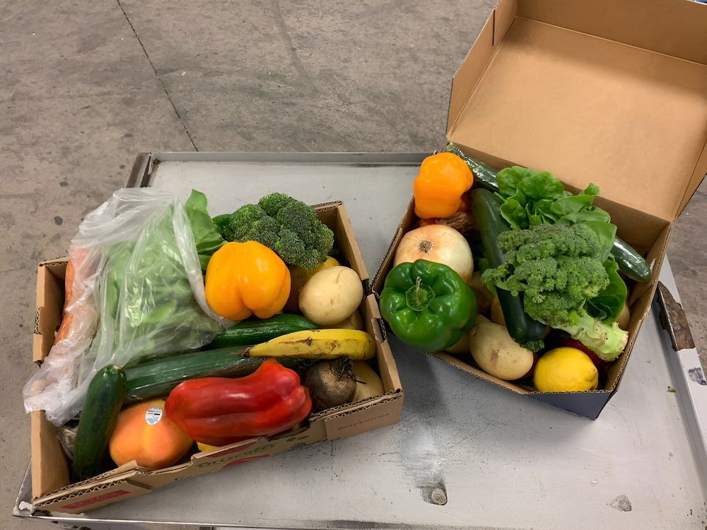 Two Cardboard Boxes Filled With Fruits And Vegetables — Central Fruit & Vegetable Wholesalers Pty Ltd In Alice Springs, NT