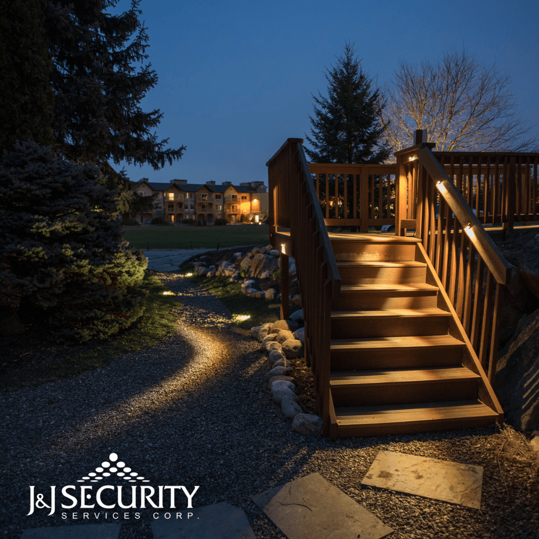 Outdoor wooden staircase with illuminated steps and path at dusk, leading to a deck.
