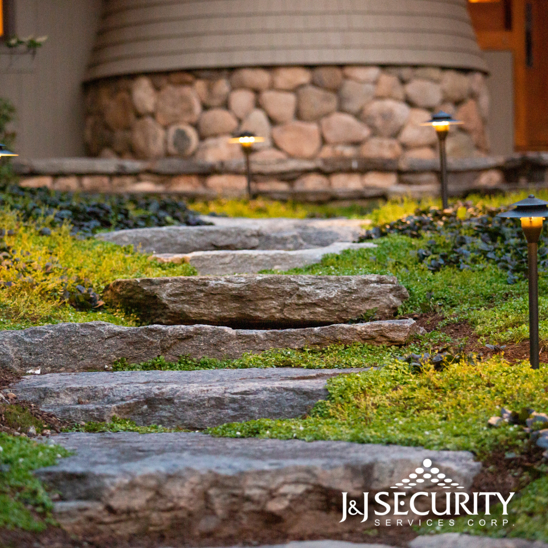 Stone steps lead up a garden path, with small lights on either side.