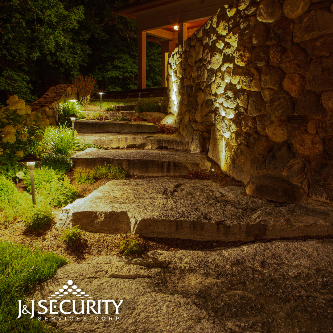 Stone steps and pathway illuminated by landscape lighting.